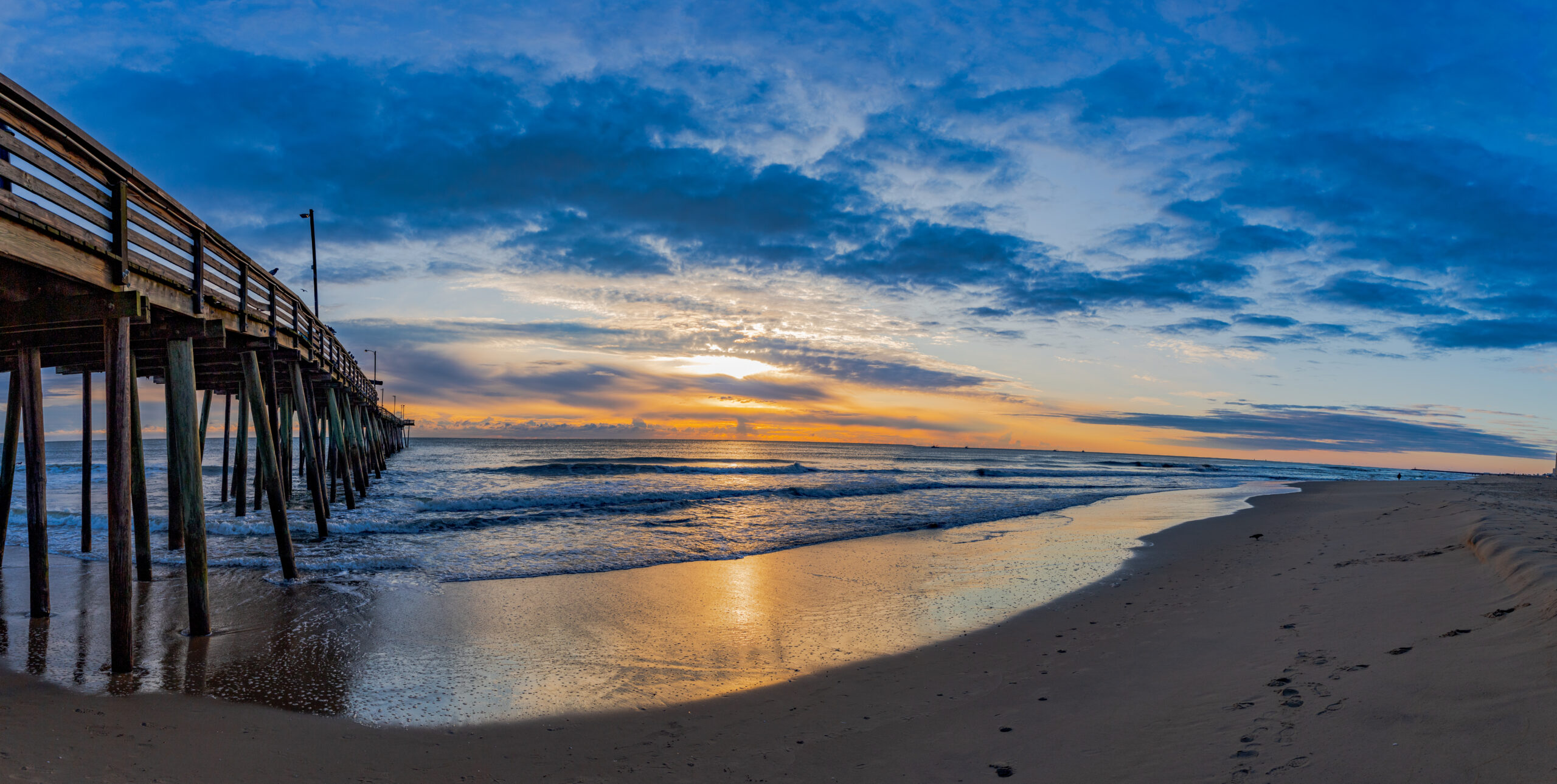 Golden sunrise framed beneath the Virginia Beach fishing pier