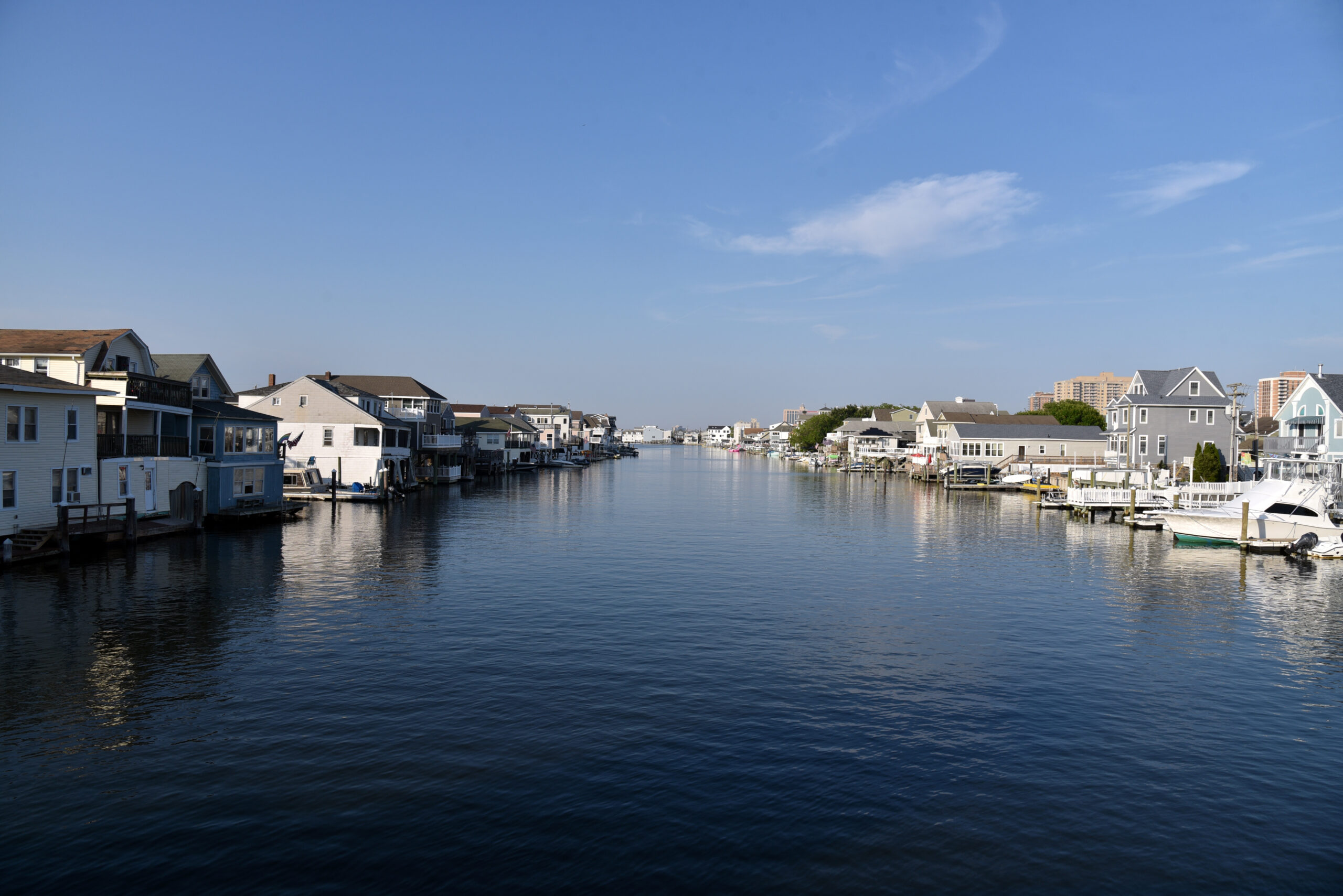 Waterfront homes with private docks and boats along a calm canal